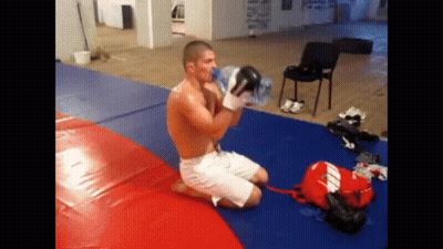 Boxer Drinking Water While Kneeling On Mat GIF
