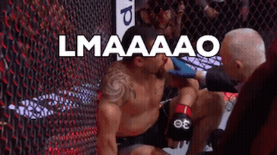 Boxer Kneeling In Ring Referee Examining Wound GIF