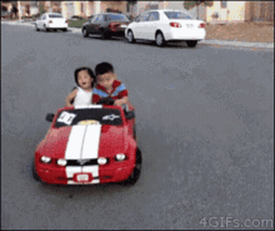 Boy And Girl Driving Red Mustang Toy Car GIF