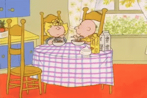 Boy And Girl Eating Cereal At Table GIF