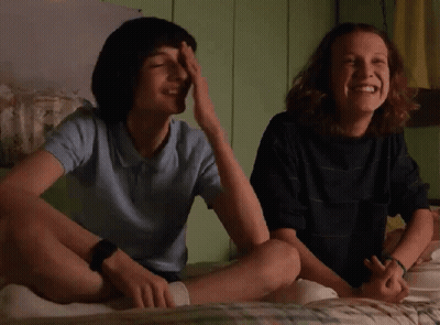 Boy And Girl Laughing On Bed GIF