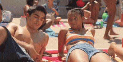 Boy And Girl Laying On Beach GIF