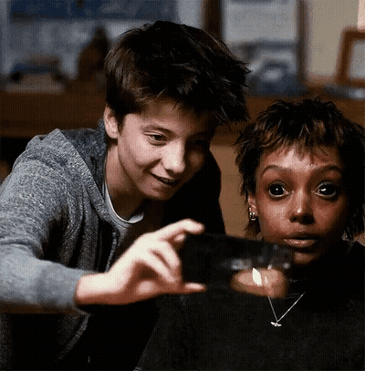 Boy And Girl Looking At Candle In Glass GIF