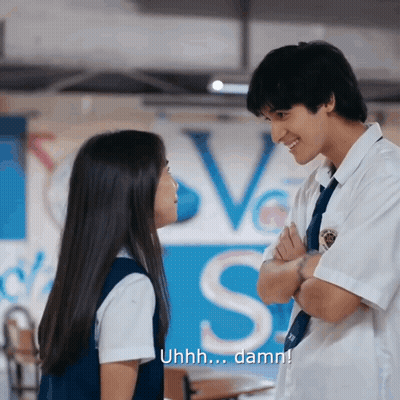 Boy And Girl Looking At Love Sign GIF