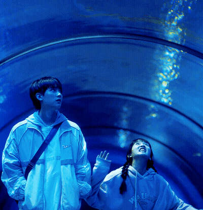 Boy And Girl Looking Up At Water In Tunnel GIF