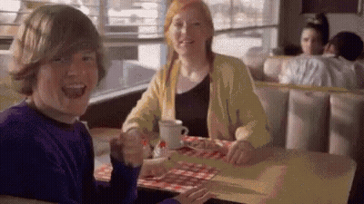 Boy And Girl Sitting At Diner Table GIF