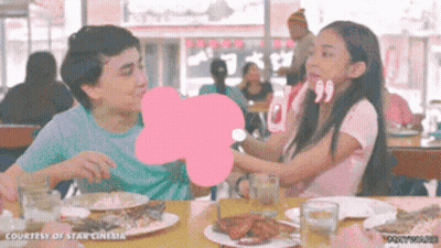 Boy And Girl Sitting At Table With Food GIF