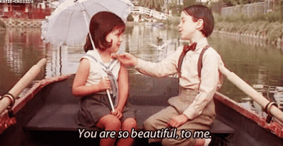 Boy And Girl Sitting In Boat On Water GIF