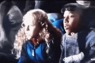 Boy And Girl Sitting In Theater Watching Movie GIF