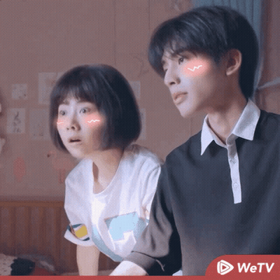 Boy And Girl Sitting Next To Each Other With WETV Logo GIF