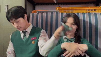 Boy And Girl Sitting On Striped Couch Holding Arm GIF