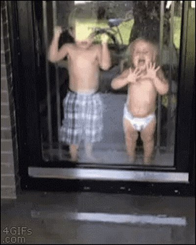 Boy And Girl Standing In Front Of Window GIF