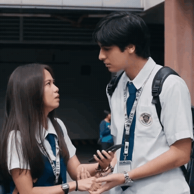 Boy And Girl Standing Together With Star Lanyard GIF