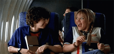 Boy And Girl Talking On Airplane GIF