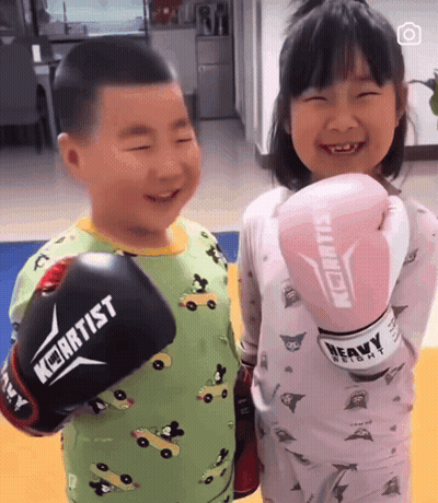 Boy And Girl Wearing Keiartist Boxing Gloves GIF