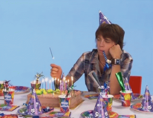 Boy Blows Out Birthday Cake Candles Wearing Happy Birthday Hat GIF