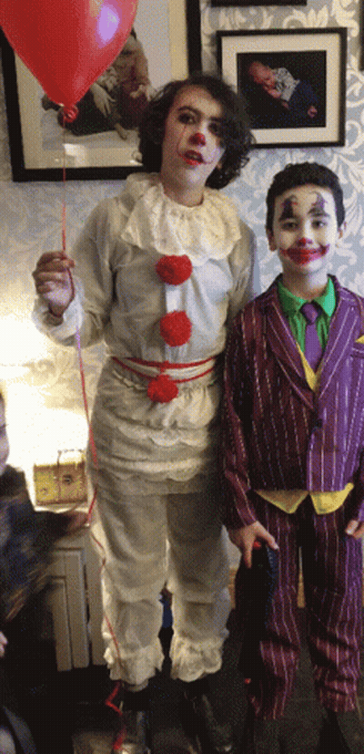 Boy Dressed As Clown Holding Red Balloon GIF