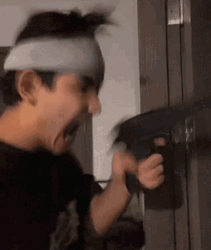 Boy Holding A Machine Gun GIF