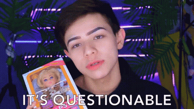 Boy Holding Doll Saying It's Questionable GIF