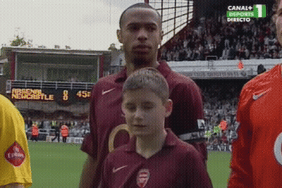 Boy In Arsenal Shirt In Front Of Soccer Player GIF