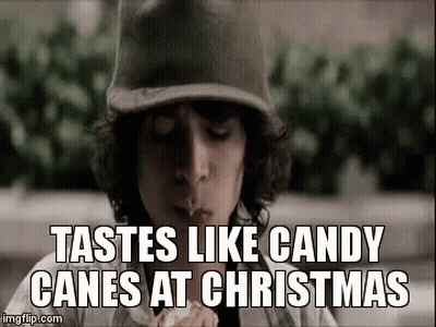 Boy In Baseball Cap Eating Candy Cane GIF