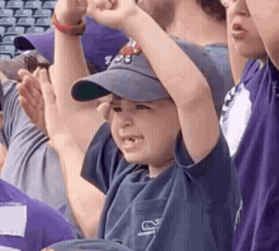 Boy In Baseball Cap Raising Fist GIF