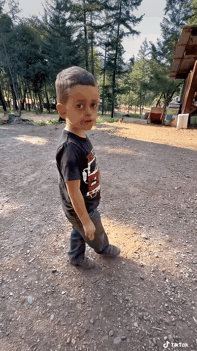 Boy In Black Thunder Shirt Standing In Dirt GIF