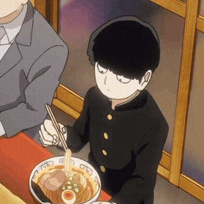 Boy In Black Uniform Eating Ramen With Chopsticks While Man Sits Behind GIF