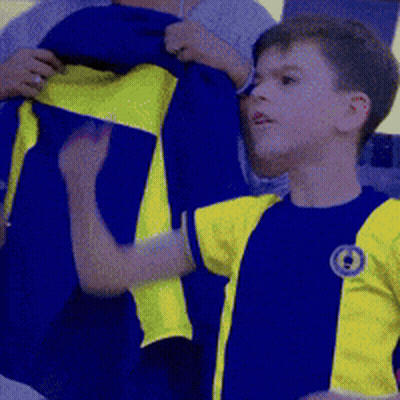 Boy In Blue And Yellow Shirt With Letter O GIF