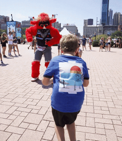 Boy In Blue Beach Shirt With Mascot GIF