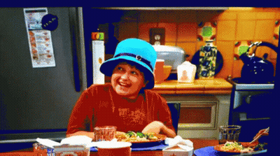 Boy In Blue Hat Sitting At Table With Food GIF