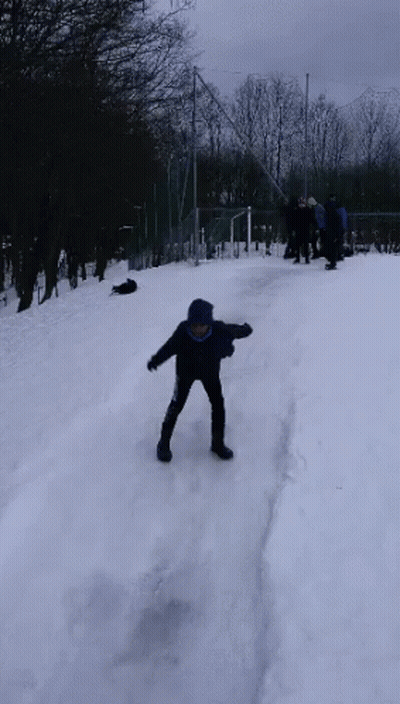 Boy In Blue Jacket Standing In Snow GIF