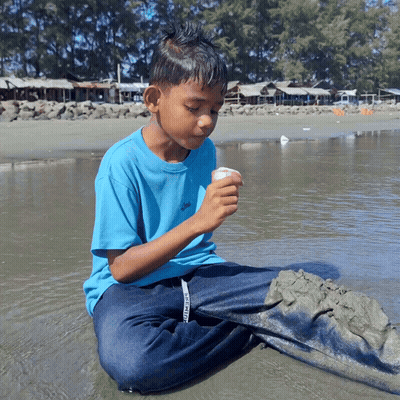 Boy In Blue Shirt Saying Converse Sits In Water GIF