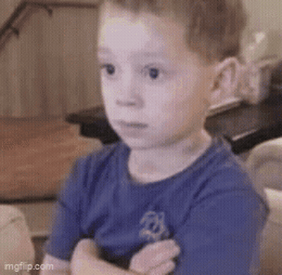 Boy In Blue Shirt Sitting Arms Crossed GIF