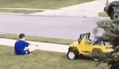 Boy In Blue Shirt Sitting Next To Yellow Toy Car GIF
