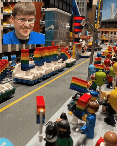 Boy In Blue Shirt Smiling In Lego City GIF