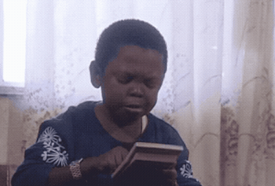 Boy In Blue Shirt With Palm Trees Holding Book GIF