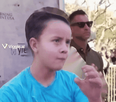 Boy In Blue Standing Before Warning Sign GIF
