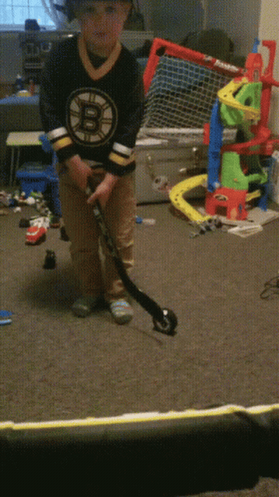 Boy In Boston Bruins Jersey Playing Hockey GIF