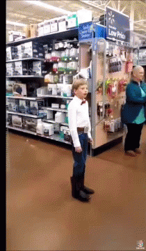 Boy In Bow Tie By Low Price Sign GIF