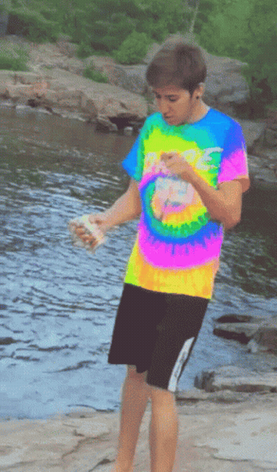 Boy In Colorful Tie-Dye Shirt By River GIF