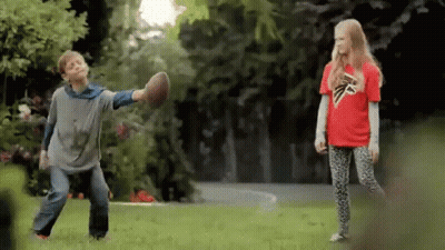 Boy In Falcons Shirt Playing Football With Girl GIF