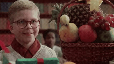 Boy In Glasses Standing In Front Of Fruit Basket GIF