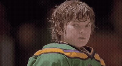 Boy In Green And Yellow Hockey Jersey On Rink GIF