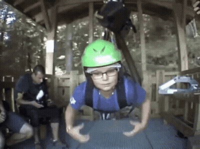 Boy In Green Helmet Hanging Upside Down GIF