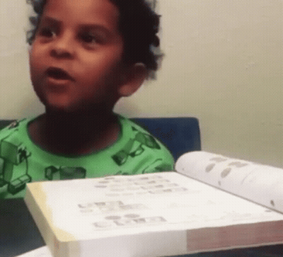 Boy In Green Shirt Reading Book GIF