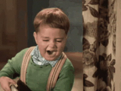 Boy In Green Sweater And Suspenders Laughing Holding Teddy Bear GIF