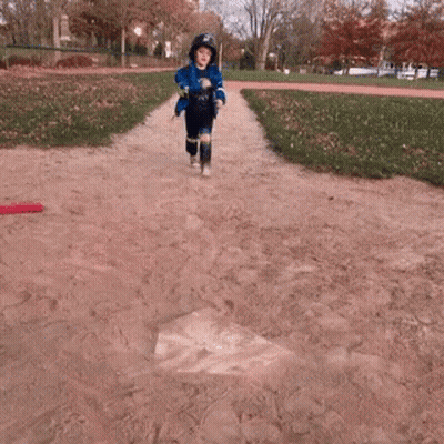 Boy In Helmet And Blue Jacket Playing Baseball GIF