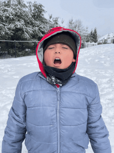 Boy In Hooded Jacket Standing In Snow GIF