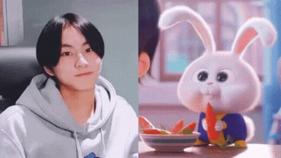 Boy In Hoodie Next To Rabbit Eating Carrot GIF